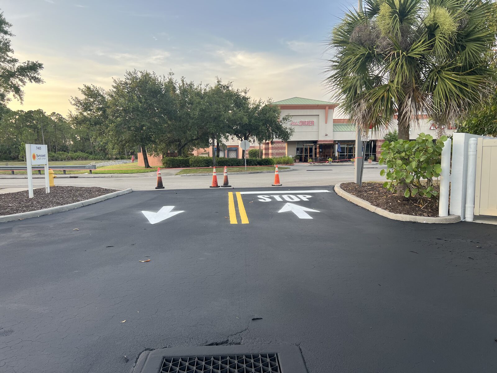 Newly line striped commercial parking lot with crisp white stalls in Fort Myers