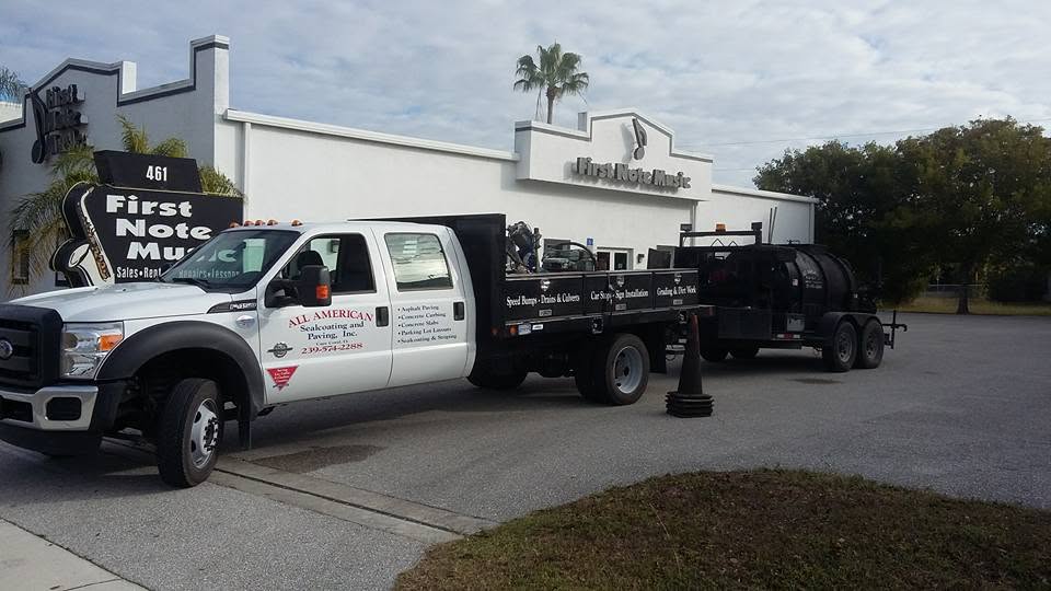 All American Sealcoating and Paving work truck and sealcoating rig on a job site
