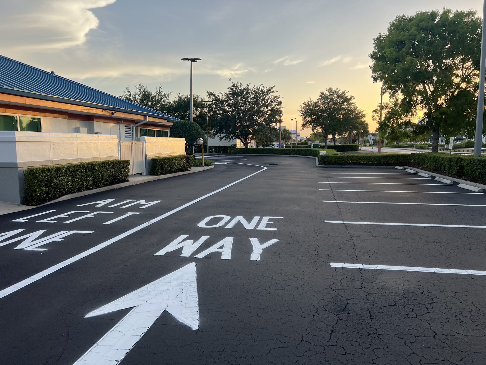 Line Striping project in Cape Coral, FL — One way pavement marking and traffic arrows painted on a sealcoated lot