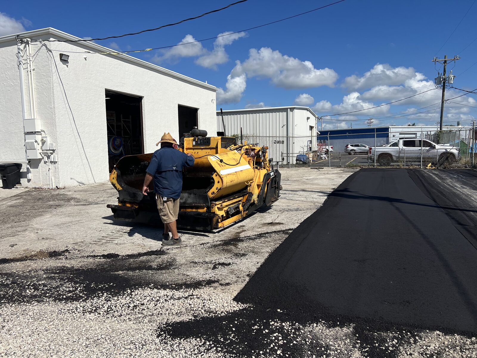 All American Sealcoating and Paving crew operating a paver on a Cape Coral job site