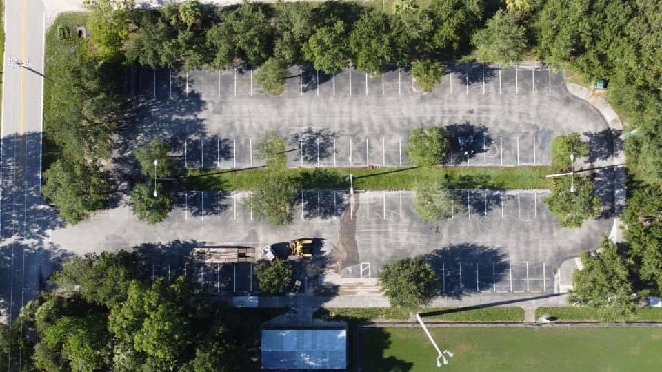 Aerial view of a gray, faded parking lot before sealcoating