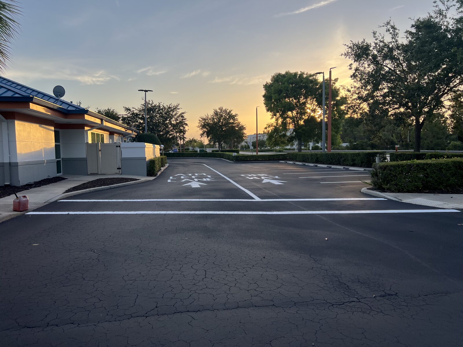 Restriped commercial parking lot photographed at dusk in Lee County, Florida